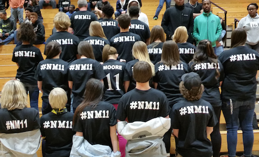 The back of the T-shirts memorialize Nathan Moore's initials and jersey number.
 